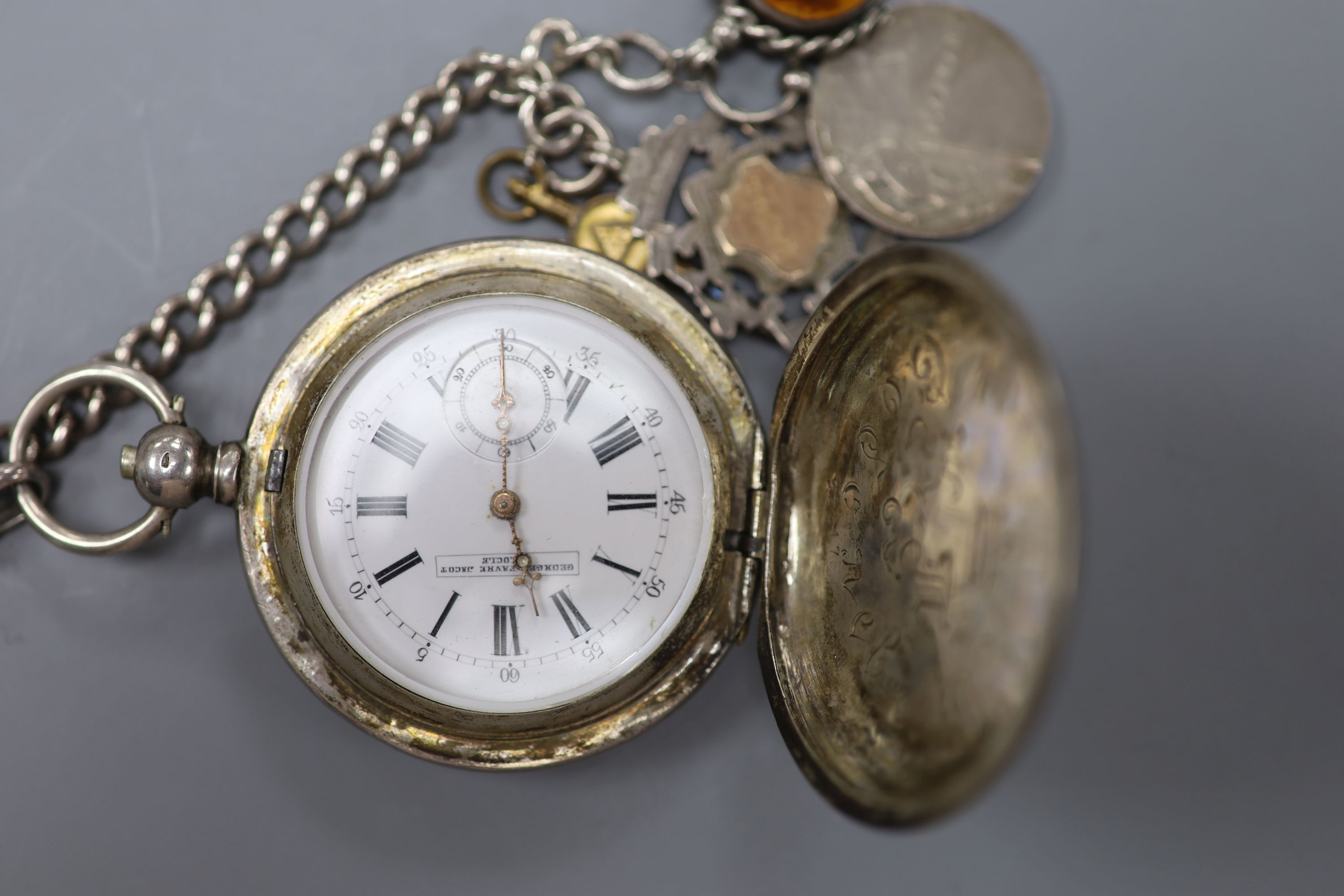 An early 20th century 875 white metal hunter keywind pocket watch by Georges Favre Jacot, on a silver albert, hung with medallions, fob and watch key